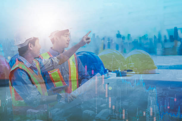 istock Double exposure-two asian engineer looking reading plan,blue print,smart city background,high rise construction development, helmet hat safety,real estate industry,investing stock market real estate 1301188894
