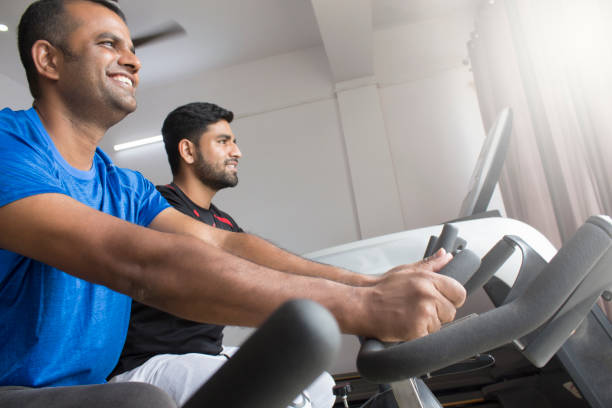istock Two Indian Males doing exercise in gym 1301188963