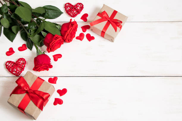 istock Valentine's day concept. Red roses, hearts and gift boxes on a white background. Mockup, place for text. 1301190736