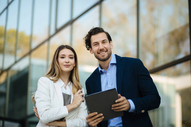 istock Business couple working online outdoors on a tablet computer 1301191216