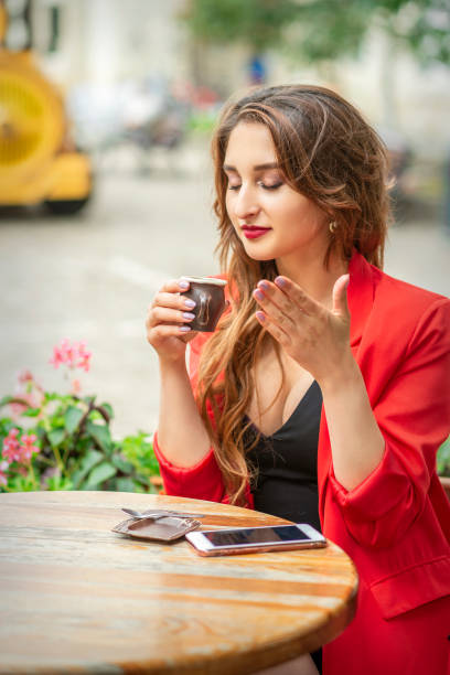 istock Beautiful young woman sniffing coffee 1301191457
