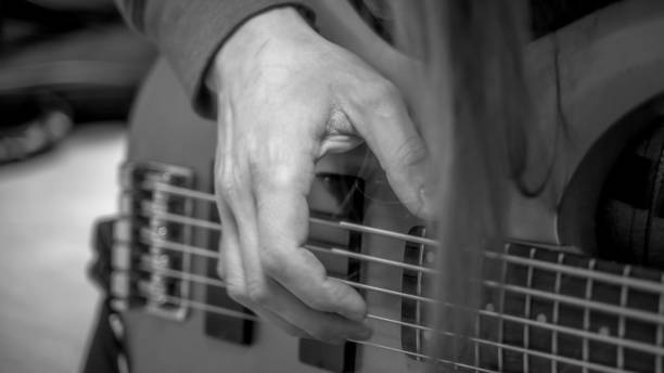 istock musician playing guitar black and white image, close up 1301192584