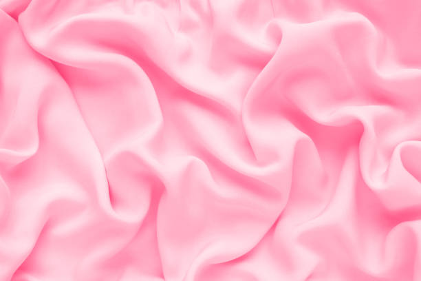 istock Silk texture, abstract background luxury pink fabric with wavy folds 1301192647