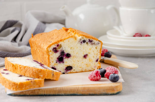 istock Vanilla cake or sponge cake with blueberries on a board on a gray concrete background. Copy space. 1301192670