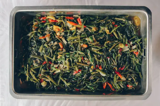 Stir fried water spinach or cah kangkung in steel pan. Asian indonesian food.