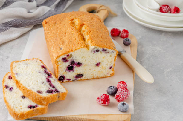 istock Vanilla cake or sponge cake with blueberries on a board on a gray concrete background. Copy space. 1301192688