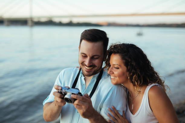 istock Couple in love looking at photos on camera 1301192737