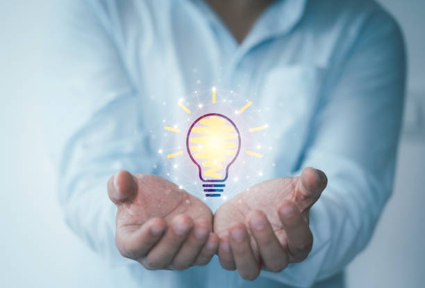 istock Businessman holding virtual lightbulb glowing on hand for creative thinking idea and innovative technology concept. 1301193218