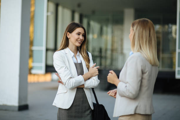 istock Two female coworkers standing and discussing ideas after work 1301194142