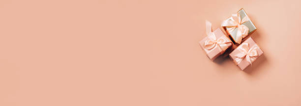 istock Festive gift boxes with satin ribbon on pastel background. Festive background 1301194936