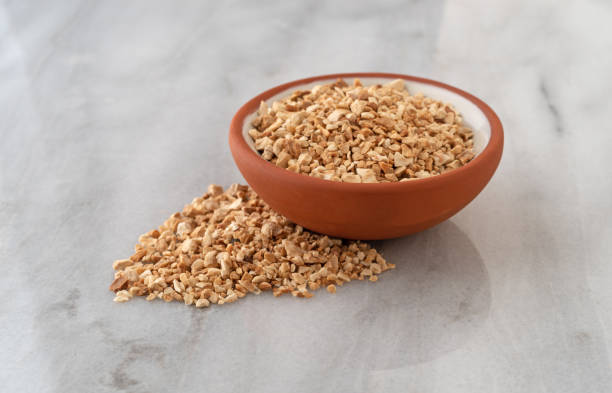 istock Cut orris root in a bowl and spilled on a marble counter top 1301196609