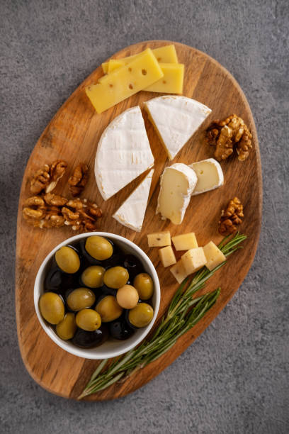 istock Assorted cheeses with nuts, olives and rosemary. 1301199313