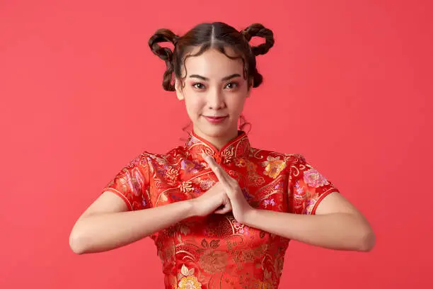 Asian chinese woman in traditional dress on red background. Chinese new year festival