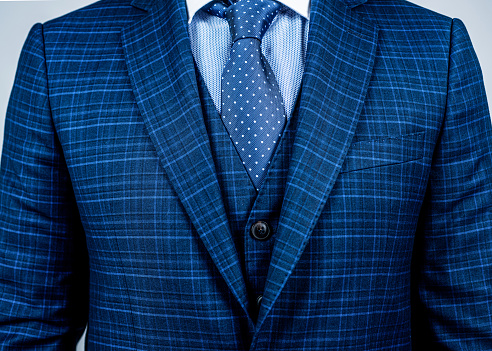 Matching tie with suit. Blue suit worn with classic tie. Necktie collection. Fashion mens accessory. Formal style. Business meeting. Polka dots will brighten up your office attire.