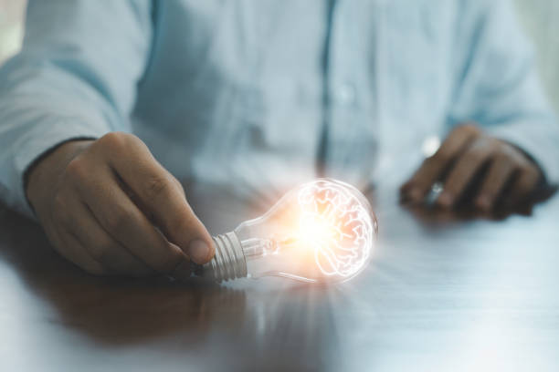 istock Businessman holding glowing lightbulb and using computer laptop to input business strategy idea , creative thinking ideas and innovation concept. 1301203487