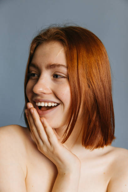 istock Girl posing with hand near her face 1301205034