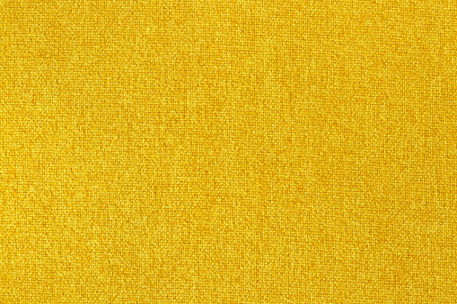 Yellow fabric texture background, seamless pattern of natural textile surface.