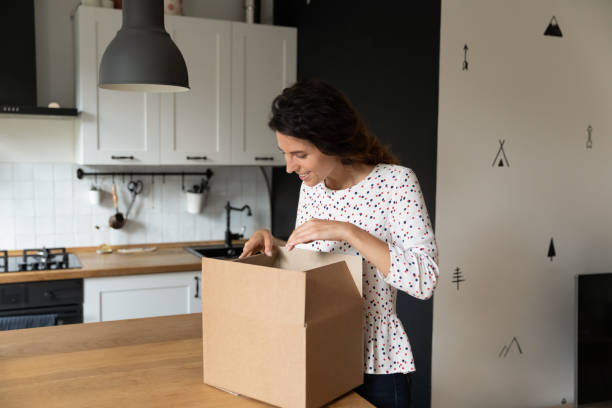 istock Excited woman unpack box with internet order 1301207834