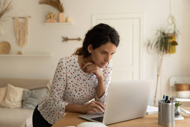 istock Caucasian woman work online on computer at home 1301207859