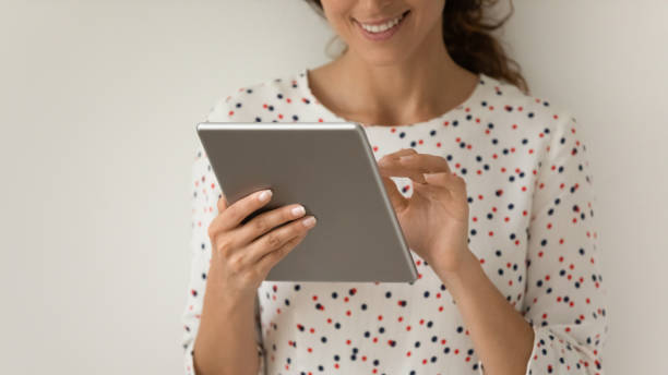 istock Close up of woman use modern tablet gadget 1301207881