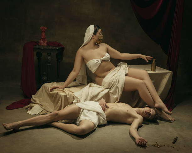 istock Modern remake of classical artwork with coronavirus theme - young medieval couple on dark background 1301209073