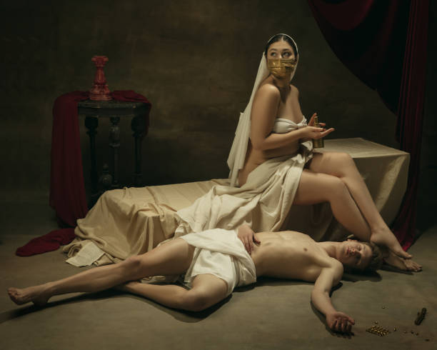 istock Modern remake of classical artwork with coronavirus theme - young medieval couple on dark background 1301209076
