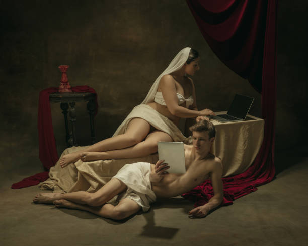 istock Modern remake of classical artwork with modern tech theme - young medieval couple on dark background 1301209127
