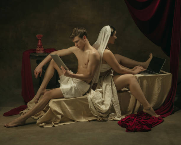istock Modern remake of classical artwork with modern tech theme - young medieval couple on dark background 1301209129