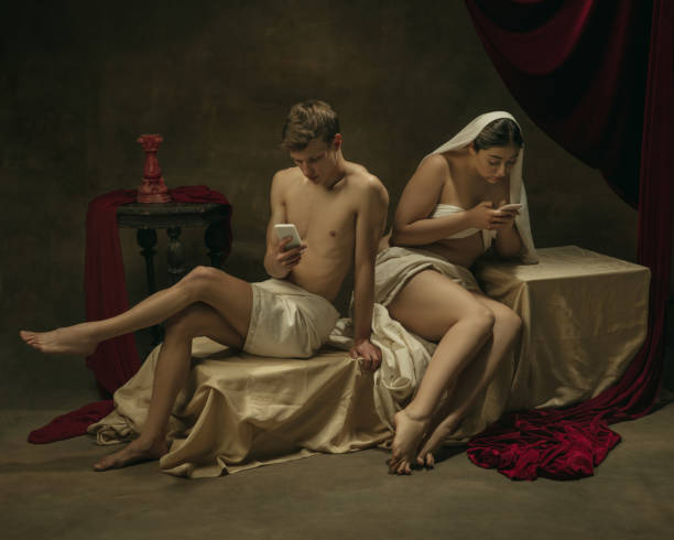 istock Modern remake of classical artwork with modern tech theme - young medieval couple on dark background 1301209141