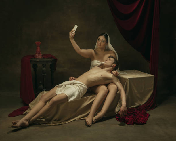 istock Modern remake of classical artwork with modern tech theme - young medieval couple on dark background 1301209152