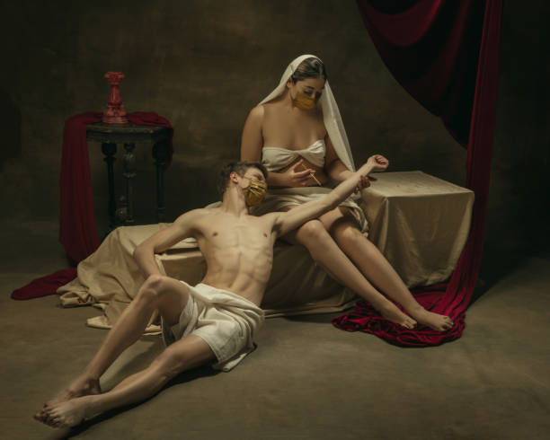 istock Modern remake of classical artwork with coronavirus theme - young medieval couple on dark background 1301209158