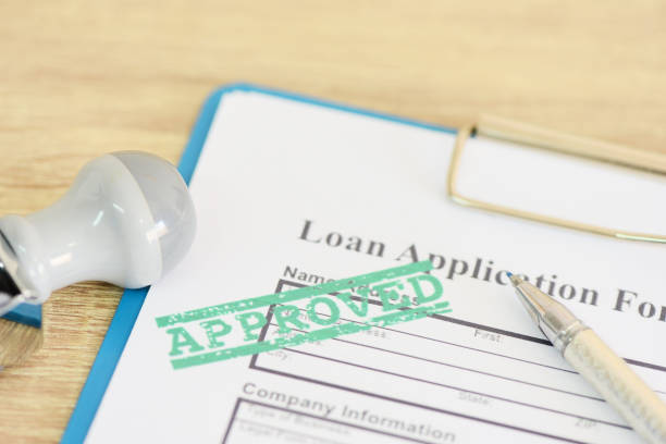 istock Loan approval, Loan application form with Rubber stamping that says Loan Approved, Financial loan money contract agreement company credit or person. 1301210659