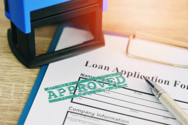 istock Loan approval, Loan application form with Rubber stamping that says Loan Approved, Financial loan money contract agreement company credit or person. 1301210665