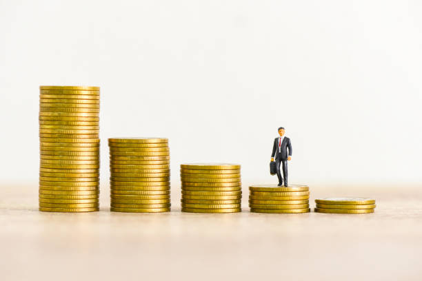 istock Golden coins stack on wooden table background, stack of coins financial growth ladder and business concept. 1301210668