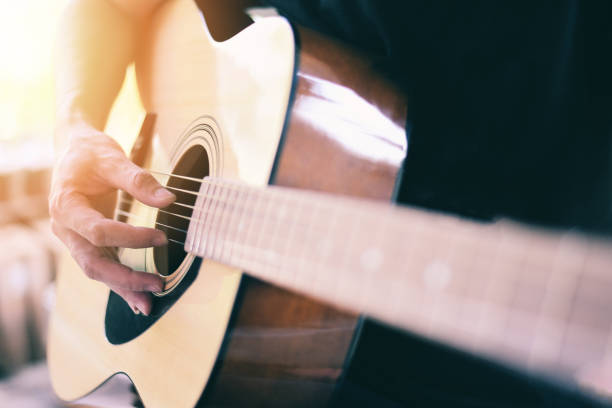 istock Home hobbies concept, Man hands playing acoustic guitar, close up guitar player Musical instrument for recreation or hobby passion. 1301210676
