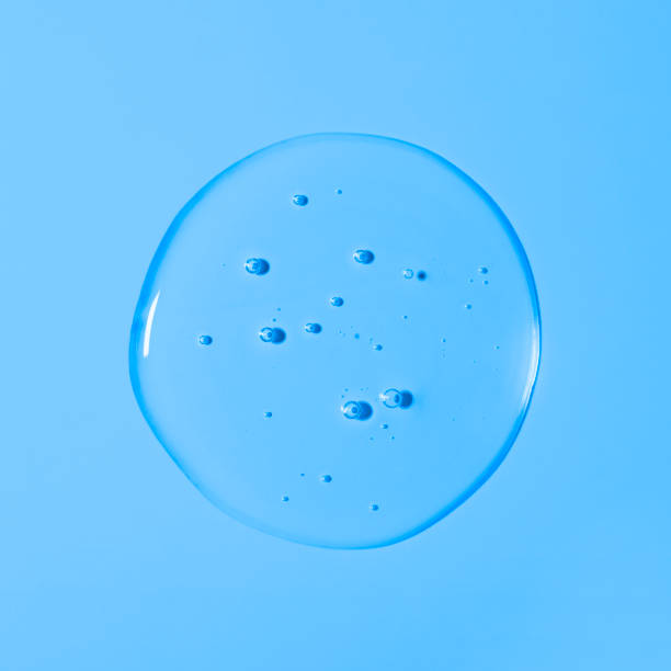 istock Clear transparent liquid gel drop or smear isolated on light blue background. Top view. Virus protection or cosmetics concept. Serum texture 1301212216