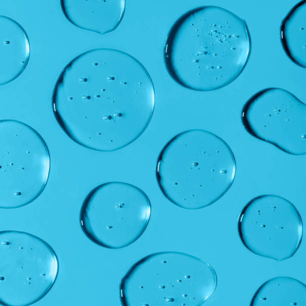 istock Transparent Gel drops forming background or pattern. Gel drops on light blue background Virus protection or cosmetics concept. Square composition 1301212256
