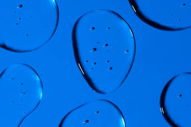 istock Transparent Gel drops forming background or pattern. Gel drops on blue background Virus protection or cosmetics concept. 1301212281
