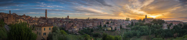 Siena town at sunrise in Tuscany, Italy Panorama of Siena old town at sunrise, a medieval and Renaissance city in Tuscany, Italy, with Mangia tower, church, old houses and palaces on a green hill torre del mangia stock pictures, royalty-free photos & images