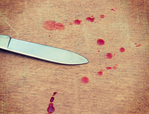 pocket knife blade and blood drops on wooden floor