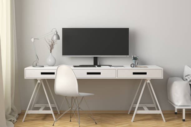 istock Wide screen display mock up. Workplace with white desk and wall. 1301216513