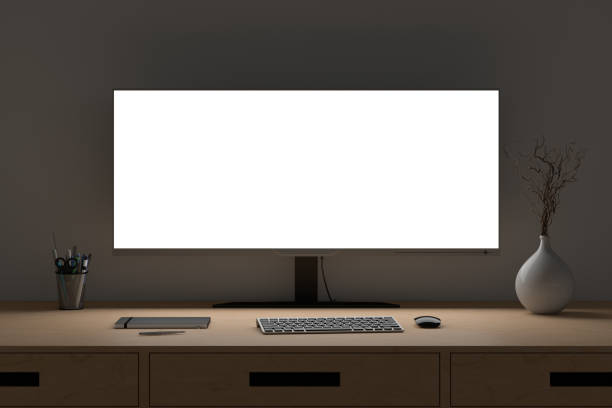 Glowing wide screen display mock up. Workspace at night with the wooden desk and white wall. Glowing wide screen display mock up. Workspace at night with the wooden desk and white wall. Front view. 3d illustration wide screen stock pictures, royalty-free photos & images