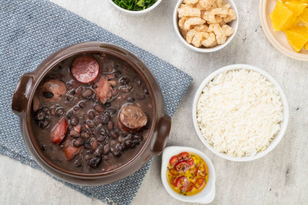 istock Traditional brazilian feijoada with rice, cracklings, kale and manioc flour 1301218423