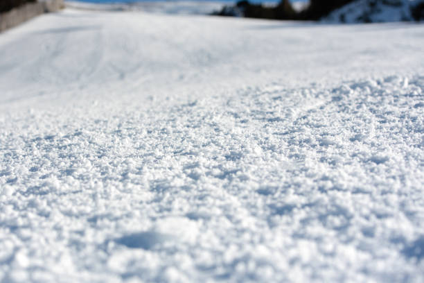 Snow on the ski slope in sunny day.