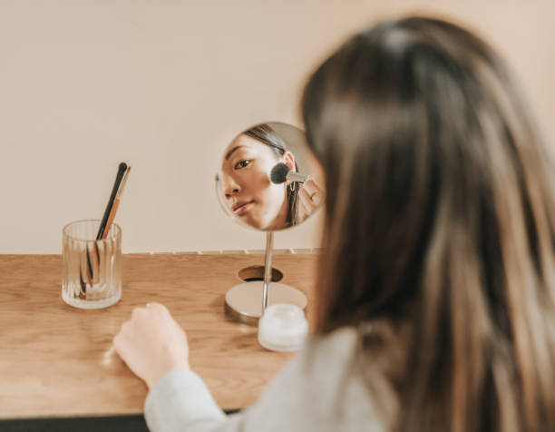 istock Woman trying on cosmetics 1301220999