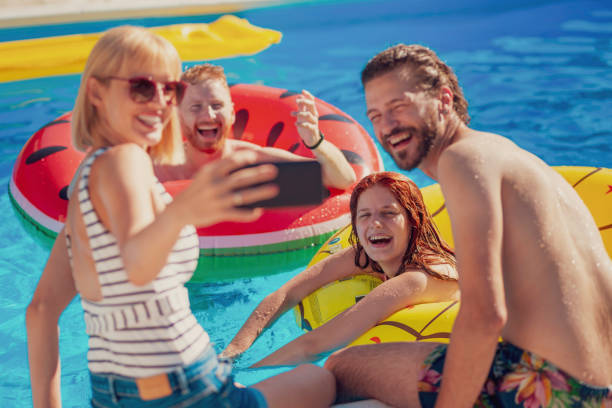 istock Friends taking a selfie at the swimming pool 1301223439