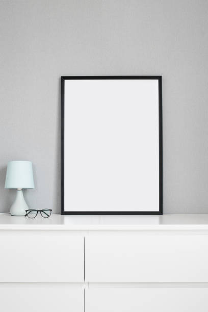 istock Blank picture frame mockup on white wall. Living room design 1301228249