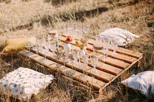 istock Wooden table with glassware arranged for picnic 1301228472