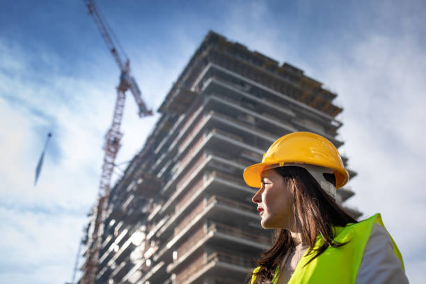 Female architect looking at on construction site stock photo... Save