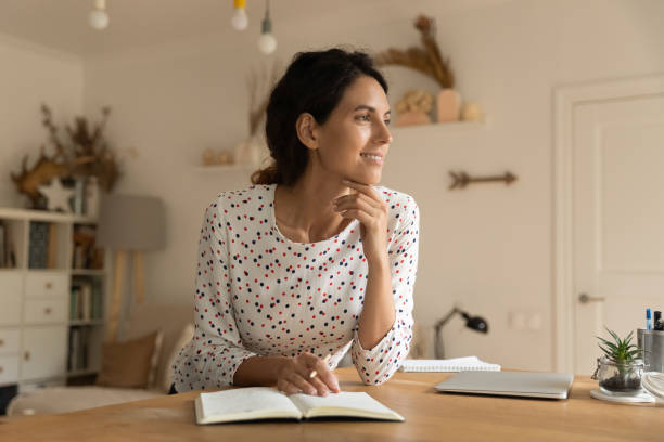 istock Happy woman write in notebook thinking planning 1301230350